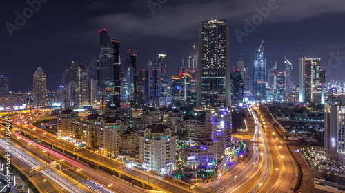 Aerial view on downtown and financial district in Dubai during all night timelapse, United Arab Emirates with skyscrapers and highways. © neiezhmakov