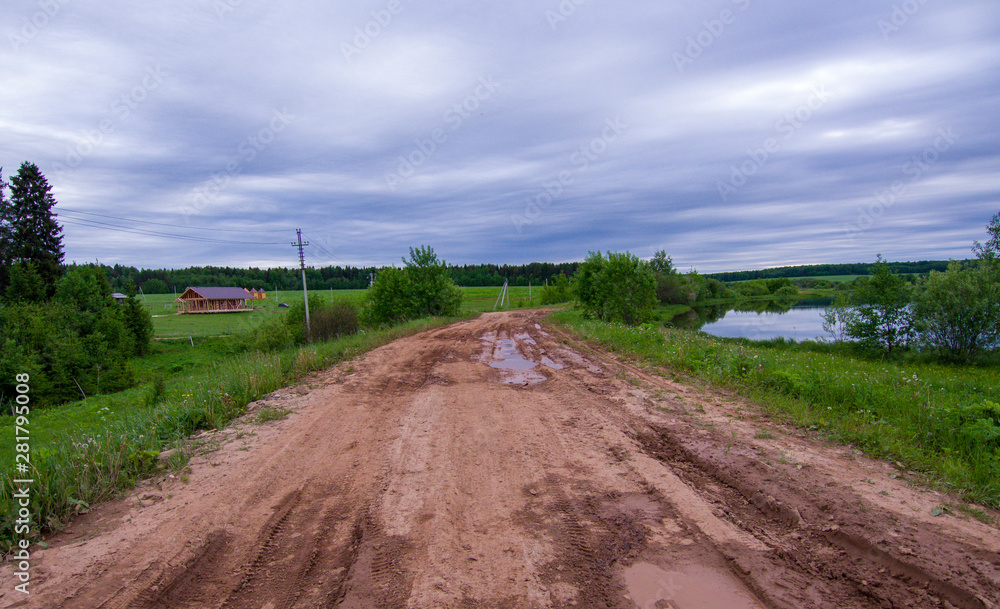 rough dirt road with puddles