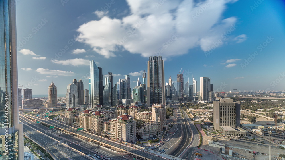 Obraz premium Skyline view of the buildings of Sheikh Zayed Road and DIFC timelapse in Dubai, UAE.