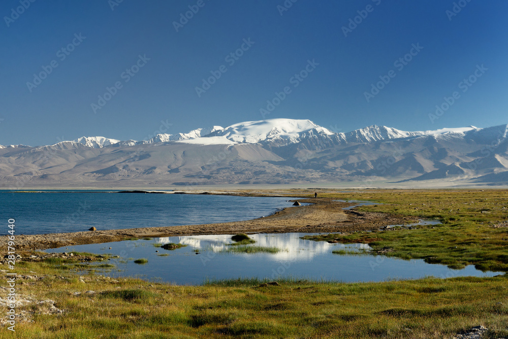 The beautiful Karakul lake by the Pamir highway. View on the lake and Peak Lenin near Karakul village in the Pamirs, Tajikistan, Central Asia