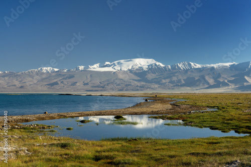 Fototapeta Naklejka Na Ścianę i Meble -  The beautiful Karakul lake by the Pamir highway. View on the lake and Peak Lenin near Karakul village in the Pamirs, Tajikistan, Central Asia