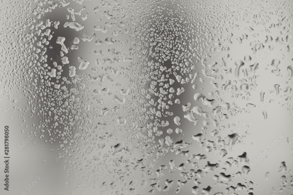Closeup macro photo of water drops captured on glass window with dark background overlooking city street. Closeup macro photo of water drops captured on glass window with dark background overlooking city street.