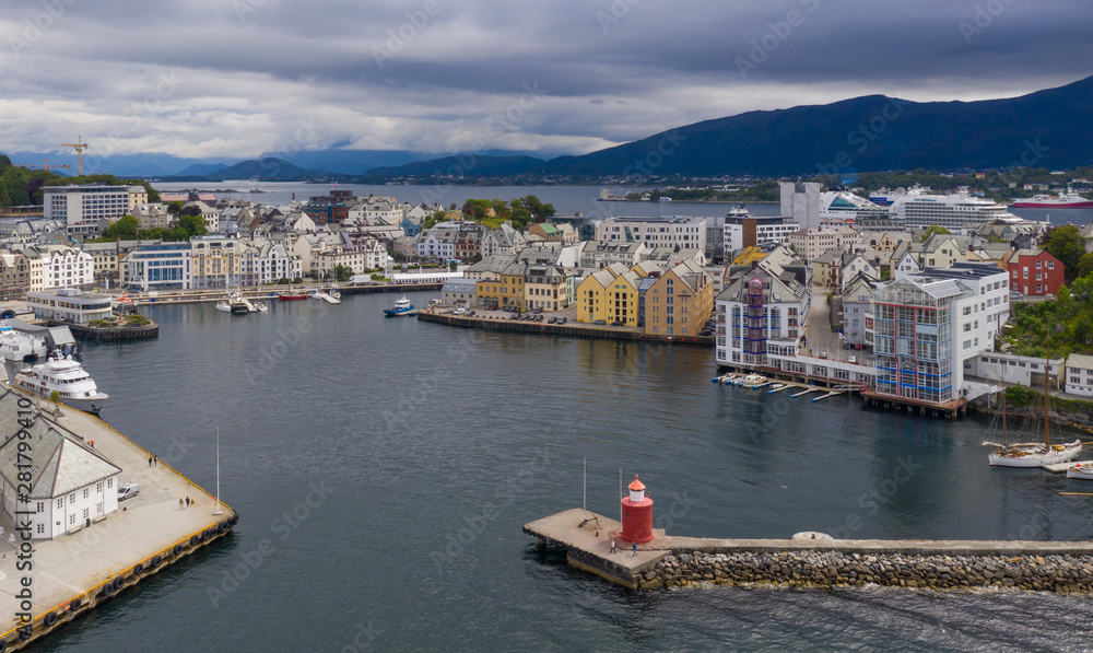 Alesund, Norway - July, 2019: Pier leading to the red lighthouse. Aerial view from above(drone shot)