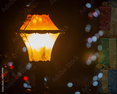 Vintage old style street light Lantern at night with Christmas decorations. Winter Holidays Tradition.