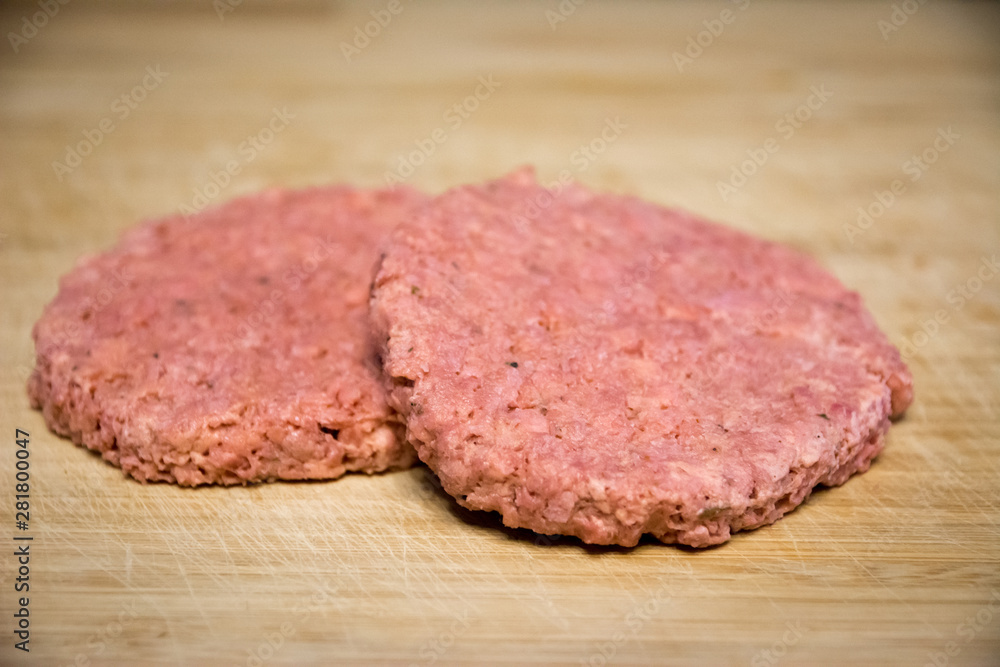 Two vegan and plant based burgers on a wooden plate Two vegan and plant based burgers on a wooden plate