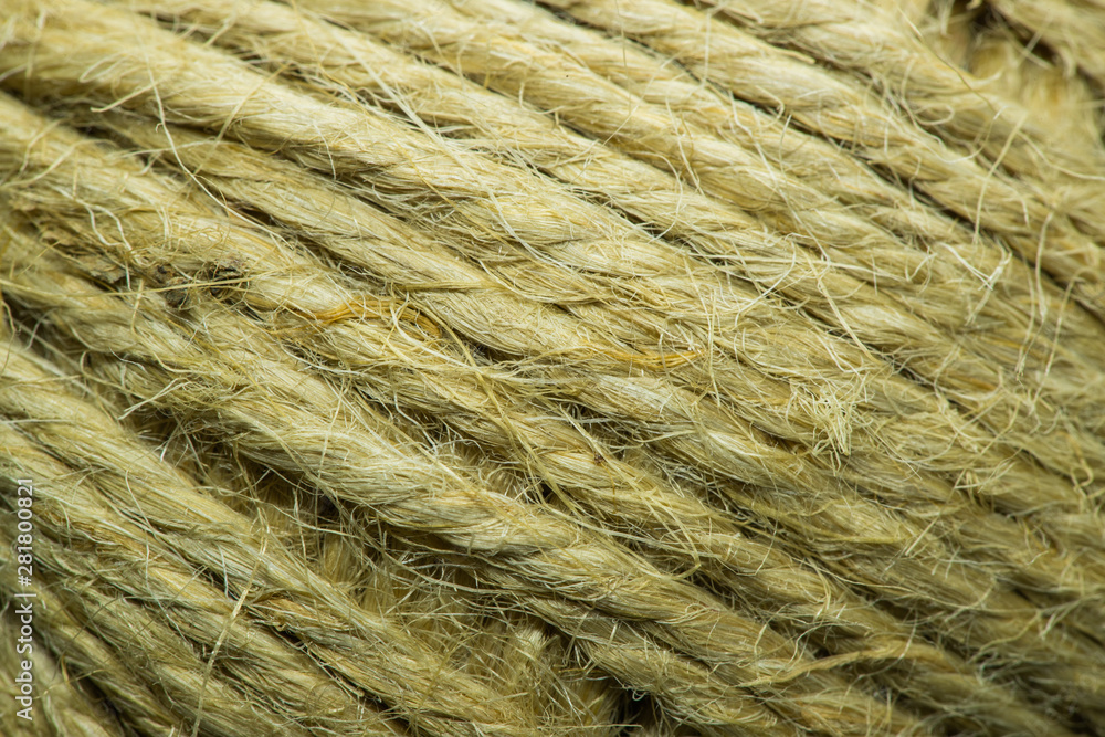 Close-up macro view of twine or string from natural fabric wrapped in a ball.