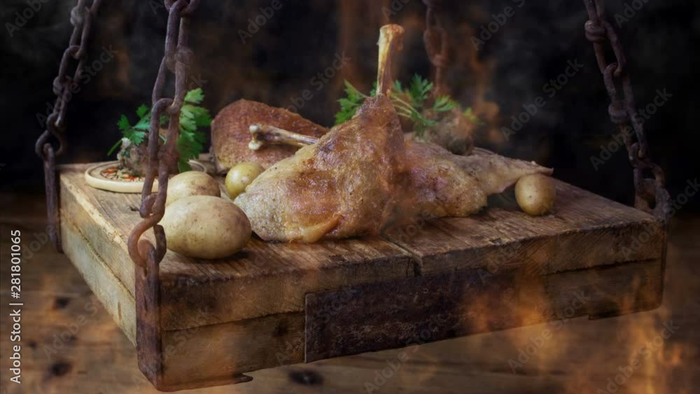 Roasted Goose Meat Served With Potatoes and Stuffing On a Rustic Wooden Surface With Burning Flames and Smoke Roasted Goose Meat Served With Potatoes and Stuffing On a Rustic Wooden Surface With Burning Flames and Smoke