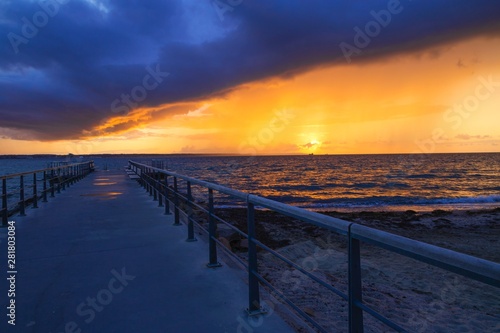 Dramatic summer sunset over sea. Scenic landscape with pier on the sea during beautiful sunset. Sweden © Elena Sistaliuk