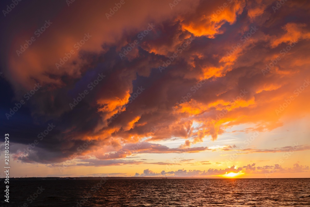Dramatic sunset through a cloudy dark sky over the ocean. Dramatic sunset through a cloudy dark sky over the ocean.