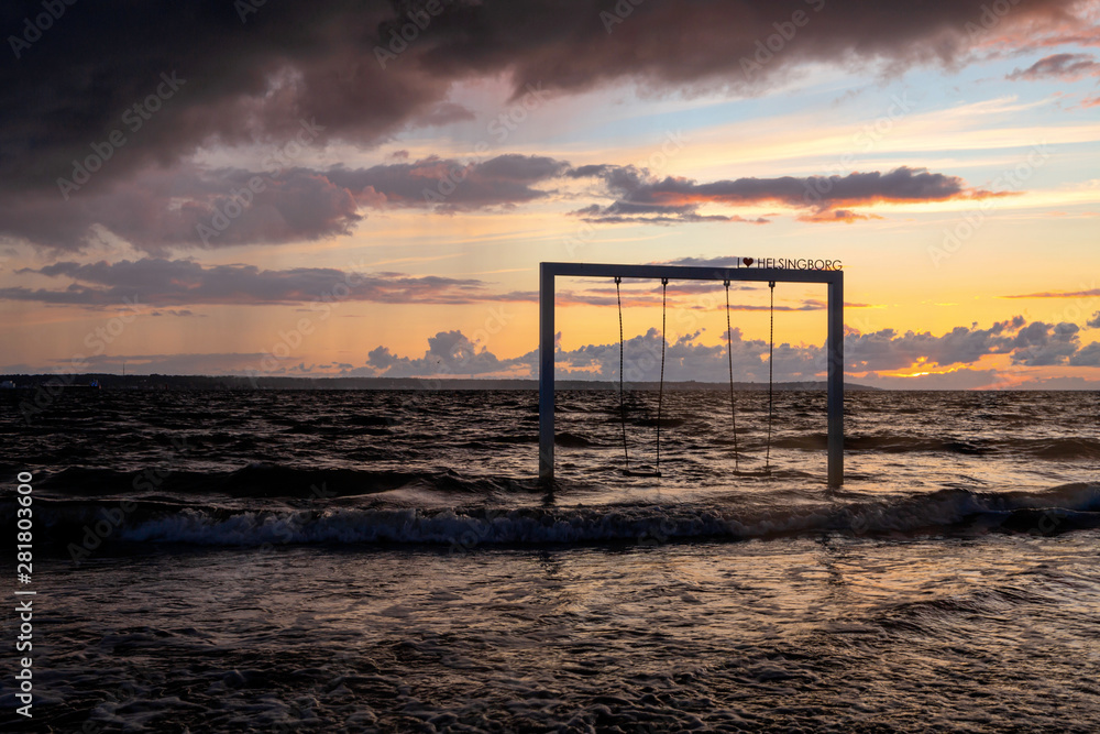 Swing on beautiful sunset sea and beach, Sweden, Helsingborg Swing on beautiful sunset sea and beach, Sweden, Helsingborg