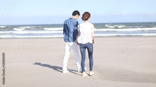 View of walking couple, Kujukuri, Chiba Prefecture, Japan photo