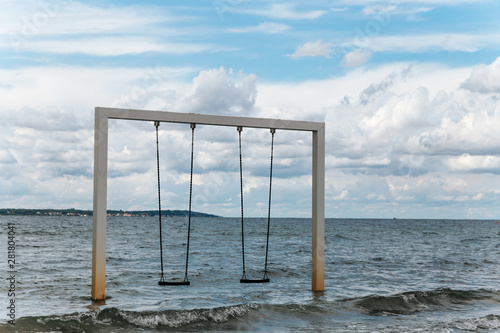 Couple swing on beautiful sea shore and beach  Sweden  Helsingborg