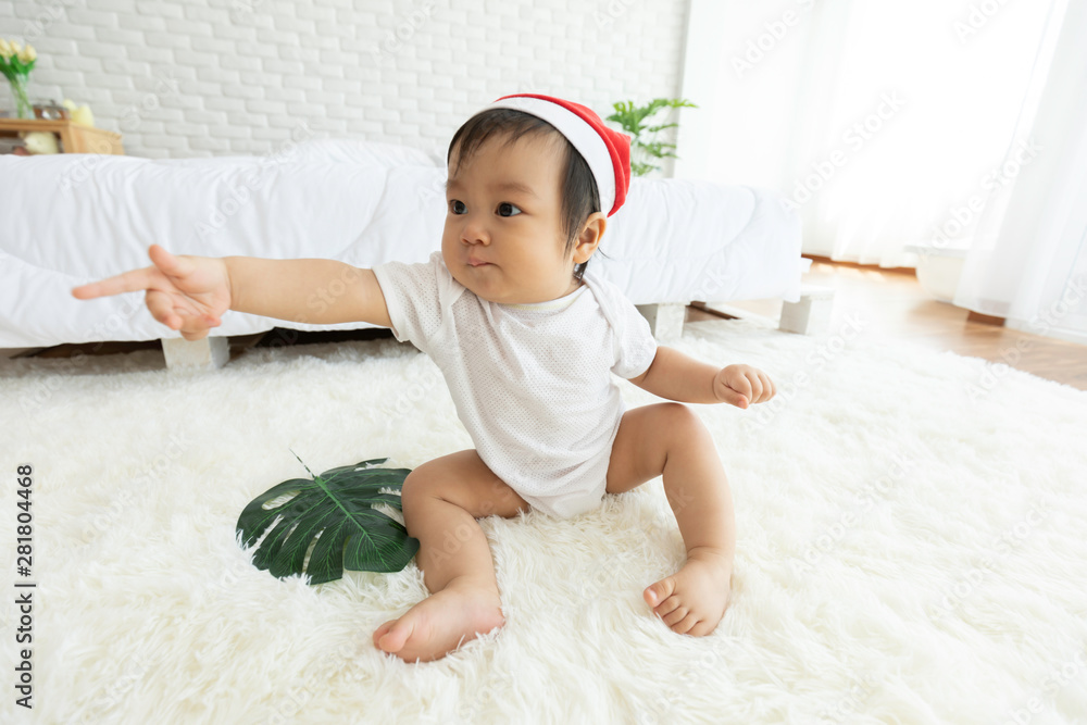 Cute Sweet Adorable Asian Baby wearing Santa hat costume sitting on white carpet smiling and playing with happiness emotional in cozy bedroom,Healthy Baby Concept Cute Sweet Adorable Asian Baby wearing Santa hat costume sitting on white carpet smiling and playing with happiness emotional in cozy bedroom,Healthy Baby Concept