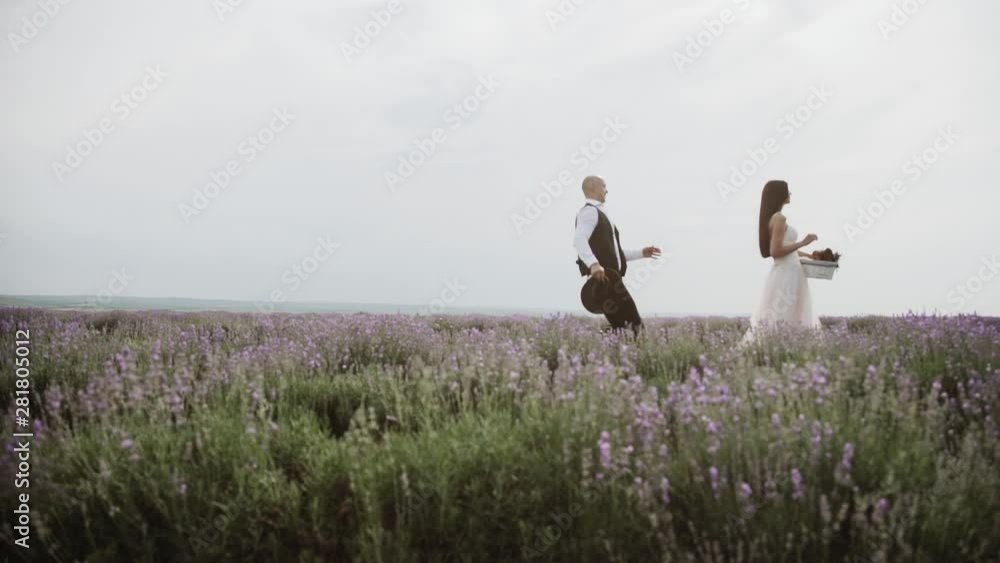 Beautiful loving couple in nature in a lavender field Beautiful loving couple in nature in a lavender field