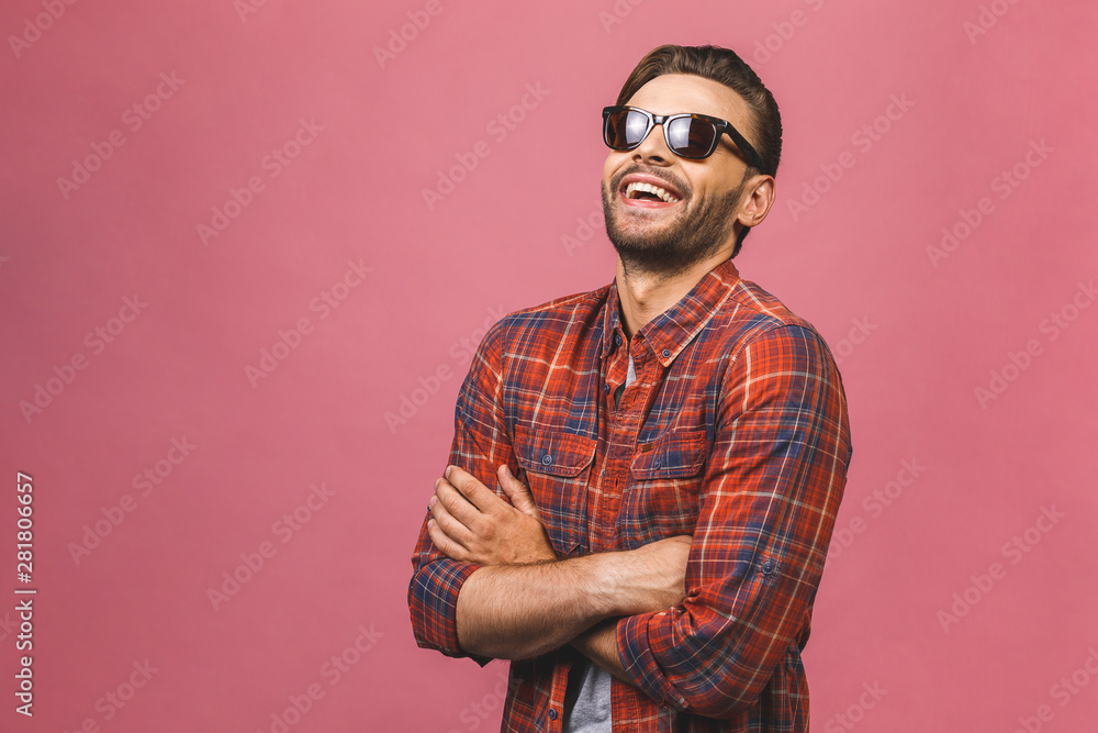 Portrait of a handsome happy cool young man in sunglasses enjoying over pink background. Portrait of a handsome happy cool young man in sunglasses enjoying over pink background.