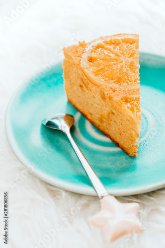 Orange cake slice on blue plate