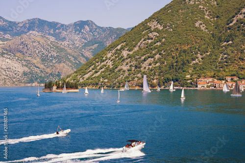 Beautiful Mediterranean landscape with sailboats on the water. Montenegro, Adriatic Sea. View of the Bay of Kotor and the Island of Saint George on sunny summer day