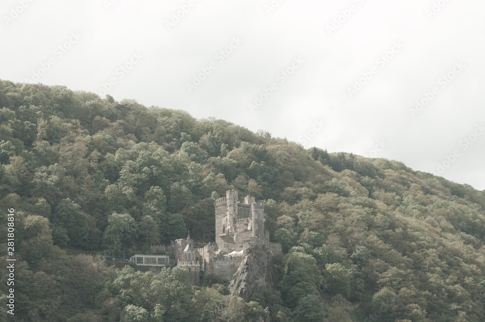 Rheinstein Castle, Germany - 27 April 2019: View of the Castle in the hill Over the Rhine river