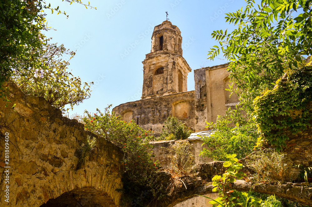 View of the ruins of the Church of Sant'Egidio, whose bell tower has miraculously escaped the earthquake of 1878 that caused the abandonment of the medieval village, Bussana Vecchia, Imperia, Italy