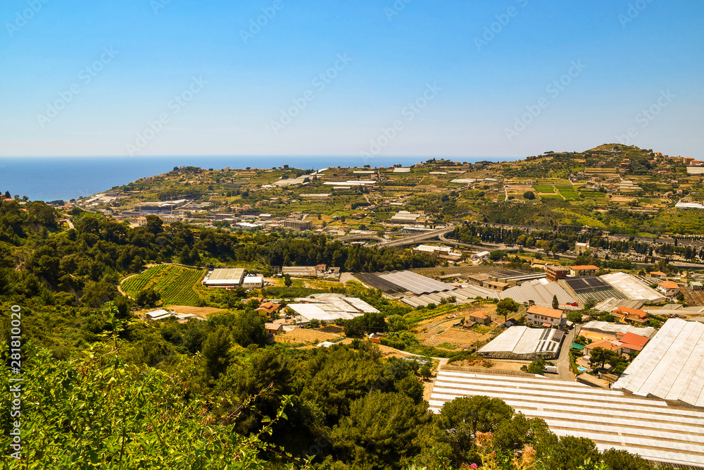 Obraz premium High angle panoramic view of the Armea Valley with greenhouses for the cultivation of flowers, a typical commercial activity of the area of Sanremo, Imperia, Liguria, Italy