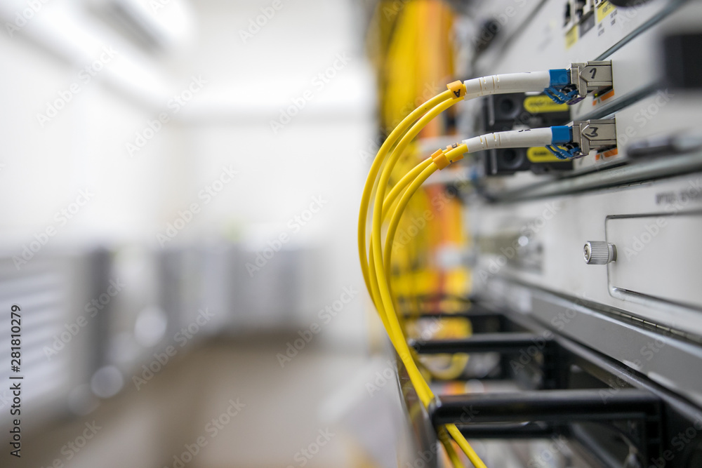 Fiber Optical connector interface. Fibre Channel swich. Severs computer in a rack at the large data center. Fiber Optical connector interface. Fibre Channel swich. Severs computer in a rack at the large data center.