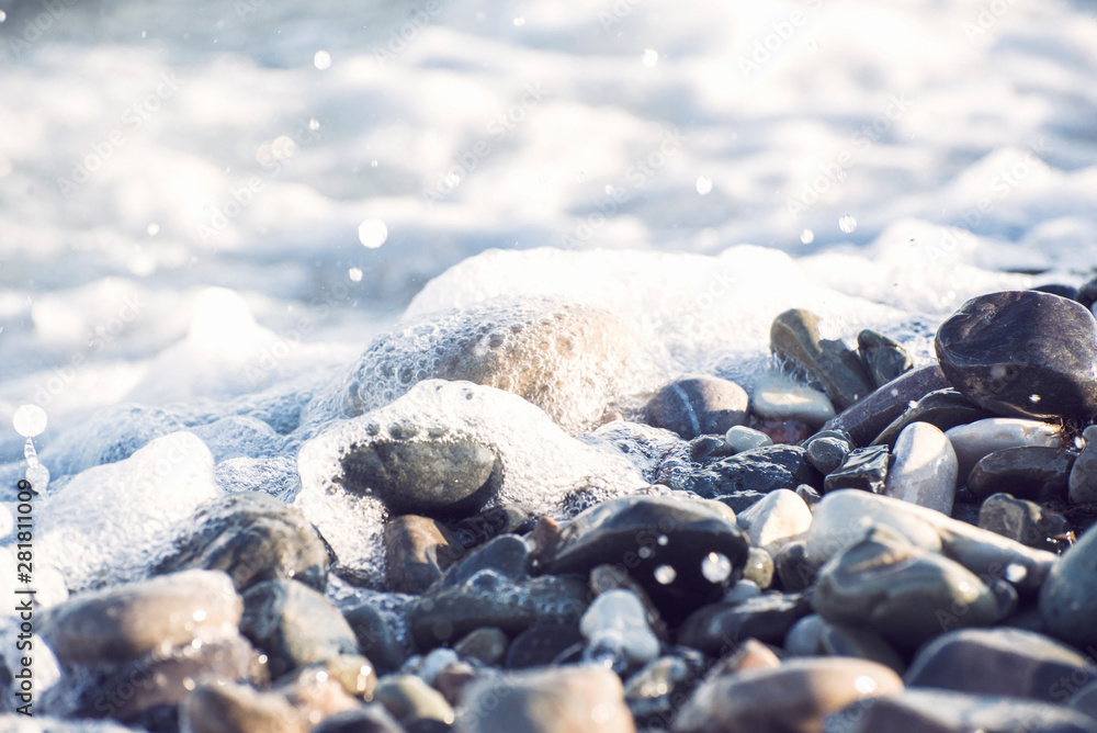 Splash of sea water and foam on the stone shore Splash of sea water and foam on the stone shore