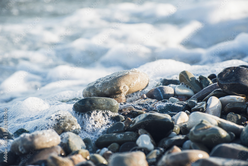 Splash of sea water and foam on the stone shore Splash of sea water and foam on the stone shore