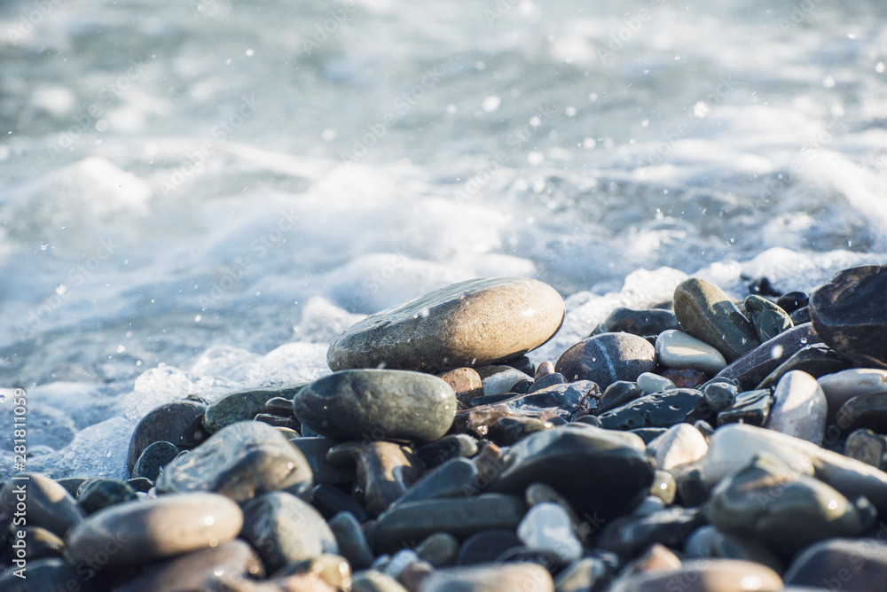 Splash of sea water and foam on the stone shore Splash of sea water and foam on the stone shore