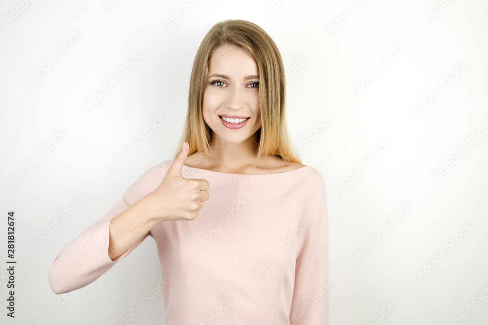 young beautiful blonde smiling woman on isolated white background showing ok sign young beautiful blonde smiling woman on isolated white background showing ok sign