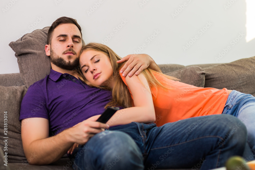 Couple napping while watching tv at their home. Couple napping while watching tv at their home.