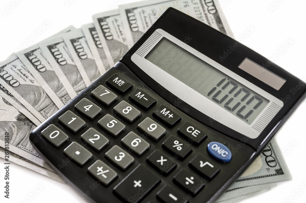 dollars and calculator on a white background, close-up. dollars and calculator on a white background, close-up.