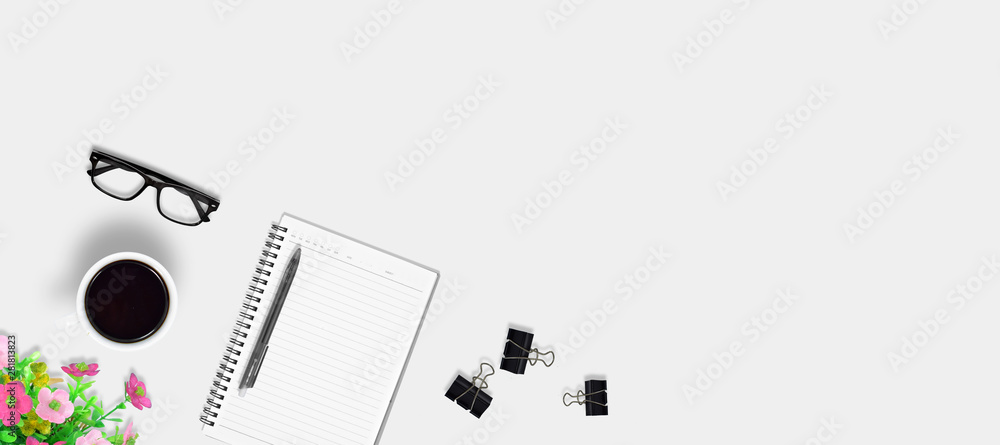Top view education and office desk with coffee, Pen, Flower bouquet, Paper clip, Notebook with copy space background Top view education and office desk with coffee, Pen, Flower bouquet, Paper clip, Notebook with copy space background