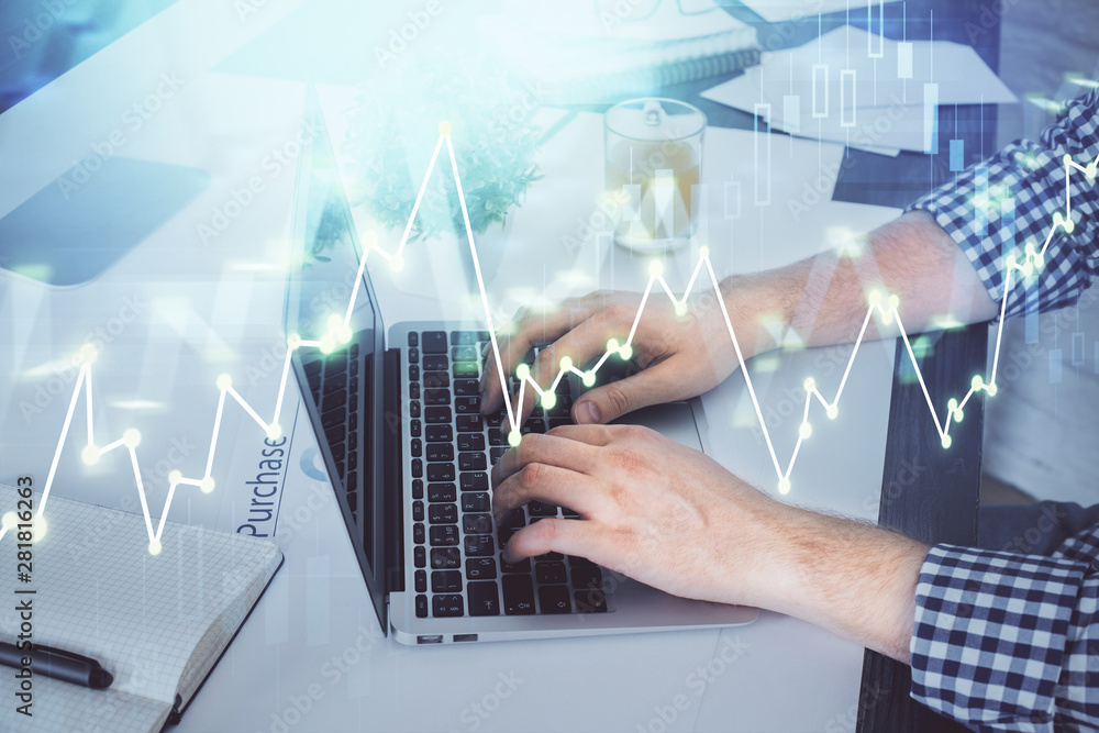 Double exposure of graph with man typing on computer in office on background. Concept of hard work. Double exposure of graph with man typing on computer in office on background. Concept of hard work.