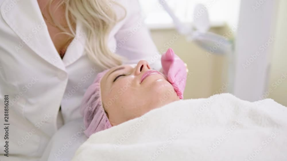 Woman getting treatment with aesthetic dermatology device Woman getting treatment with aesthetic dermatology device