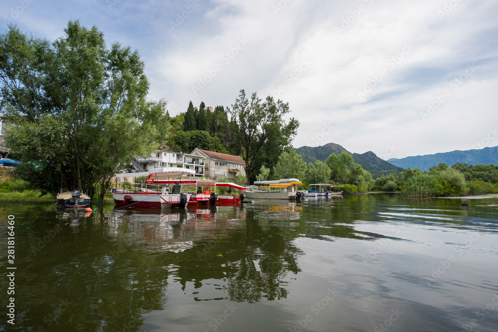 Anchored excursion boats near the lake Lake Skadar National Park Montenegro, tourist season in Virpazar town