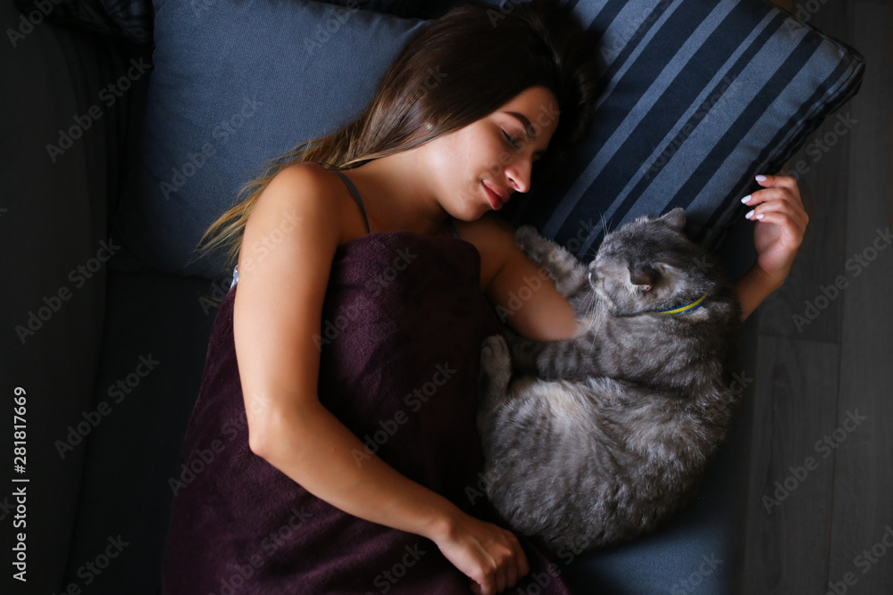 soft focused girl sleeping at home wit his cat 