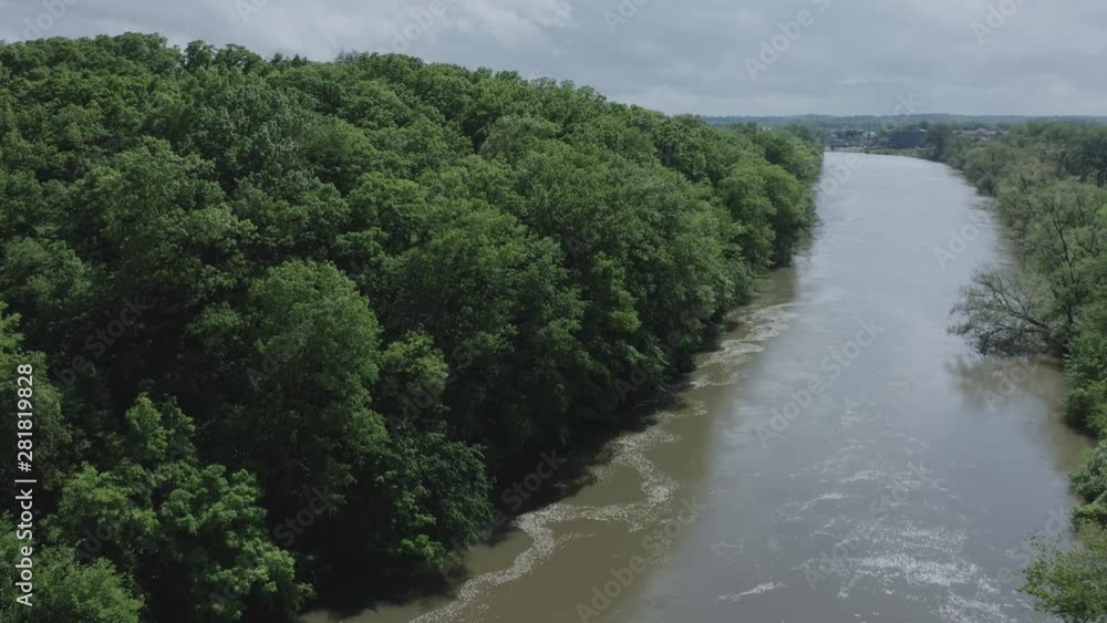Drone rises to reveal a rolling river in the Midwest USA. in the summer, in 4K. Drone rises to reveal a rolling river in the Midwest USA. in the summer, in 4K.