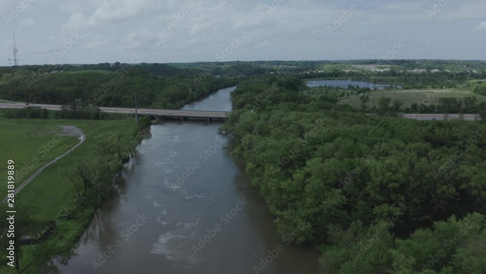 Drone flies over a river toward a lone highway in the Midwestern USA. in summer, in 4K. Drone flies over a river toward a lone highway in the Midwestern USA. in summer, in 4K.