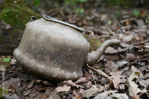 Old broken junk thrown kettle