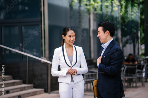 Photography Portrait of two young, confident and attractive Asian business people standing in a city during the day