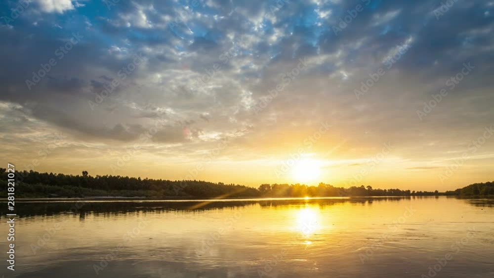 Golden sunrise with dramatic cloudscape over the lake video