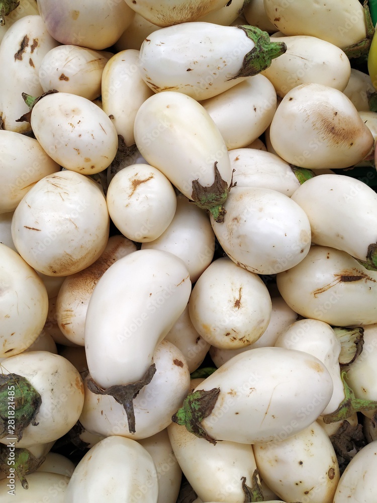 White and oval eggplant. Fresh greens for salad and cookin White and oval eggplant. Fresh greens for salad and cookin