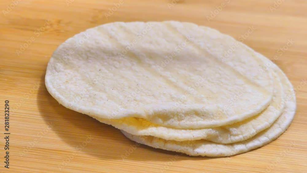 Picking up two corn tortillas Picking up two corn tortillas