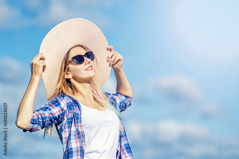 Closeup portrait happy beautiful girl in beige hat enjoying the sun and flowers. concept freedom vacation Closeup portrait happy beautiful girl in beige hat enjoying the sun and flowers. concept freedom vacation