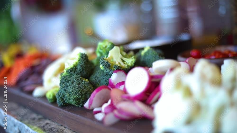 A slow Panning Shot over a platter of vegetables including broccoli, cauliflower, mushrooms, carrots, beats, radishes, etc... A slow Panning Shot over a platter of vegetables including broccoli, cauliflower, mushrooms, carrots, beats, radishes, etc...