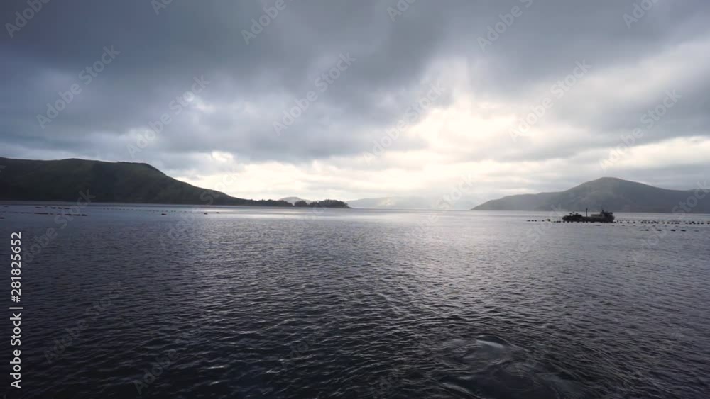 SLOWMO - Panorama view of ocean, New Zealand greenshell mussel farms, bays, hills, sky, clouds and sun SLOWMO - Panorama view of ocean, New Zealand greenshell mussel farms, bays, hills, sky, clouds and sun