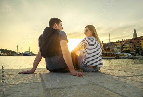 Happy couple of lovers relaxing on the sea pier