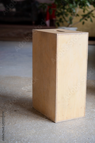 Apple boxes are wooden boxes with holes on each  in film production.
