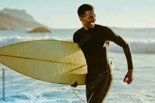 Smiling african male surfer