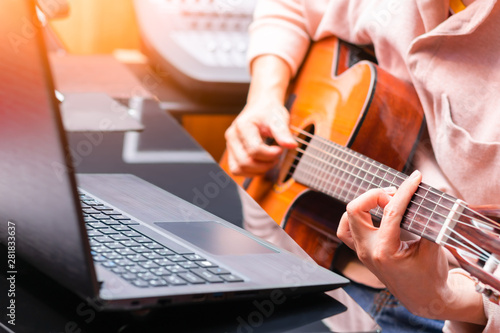 Fototapet man enjoy learning online guitar lesson from internet